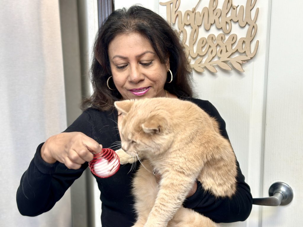 Susan and her cat Vega. At 15 pounds she could not have lifted him. That all changed when she drank pineapple skin tea and ginger-cinnamon tea that removed the inflammation.